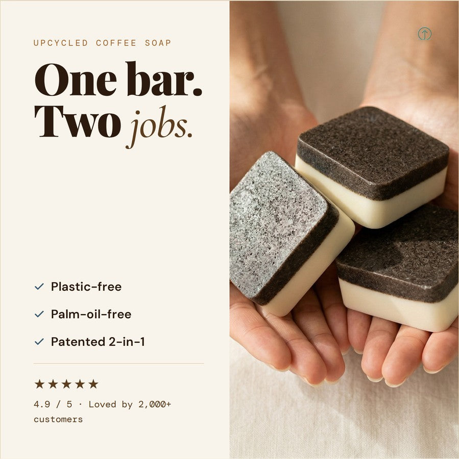 One bar, two jobs — hands holding stacked 2-in-1 coffee soap bars, showing the coffee scrub side and the cream cleansing side