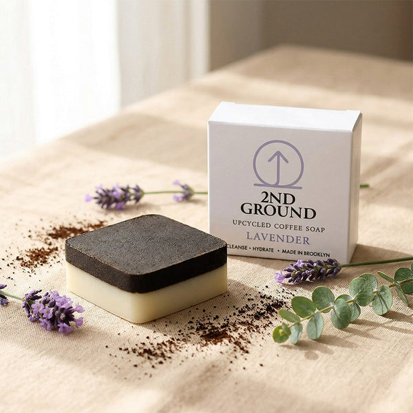 2nd Ground Lavender upcycled coffee soap bar next to its paper box with dried lavender and coffee grounds