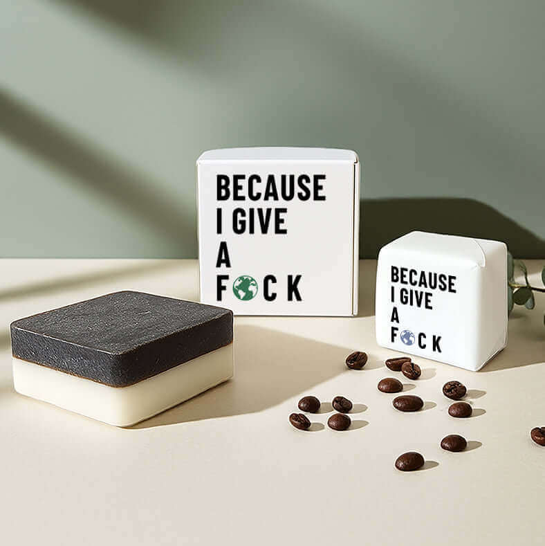 2-in-1 exfoliating soap bar made with upcycled coffee, next to box labeled 'Because I Give a F🜃CK